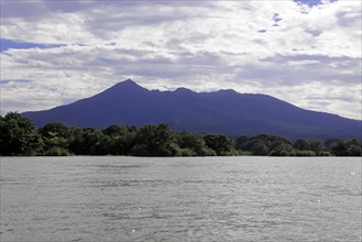 Granada, Nicaragua, Wide view of Lake Nicaragua in front of a mountain, spanned by a blue sky with