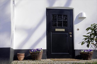 House entrance, Keitum, Sylt, North Frisian Island, Black front door of a house with side light,