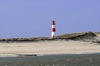 Lighthouse with blue sky at the elbow, North Sea, North Sea island, island, Sylt, red and white