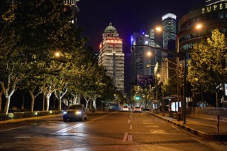Shanghai by night, China, Asia, Illuminated night view of a city street with modern buildings and