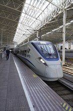 Fast trains, CRH on the platform, Hongqiao railway station, Shanghai, China, Asia. Travellers walk