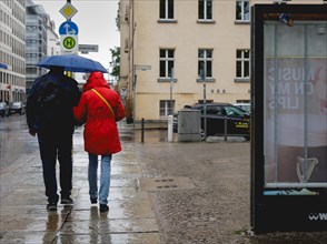 Couple walking under an umbrella in the rain, taken in Berlin, 19/04/2024