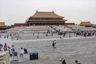 China, Beijing, Forbidden City, UNESCO World Heritage Site, visitors walk across a large square in