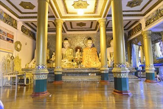 Shwedagon Pagoda, Yangon, Myanmar, Asia, Golden Buddha statues in a richly decorated interior of a