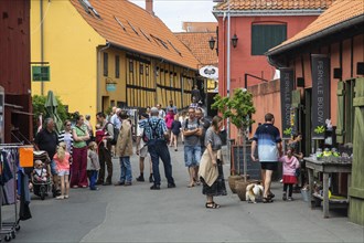 People in a narrow street in Svaneke on the island of Bornholm, Baltic Sea, Denmark, Scandinavia,
