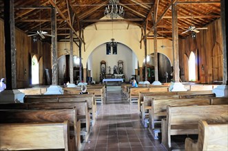 Church of San Juan del Sur, Nicaragua, Central America, View into the nave with wooden benches and