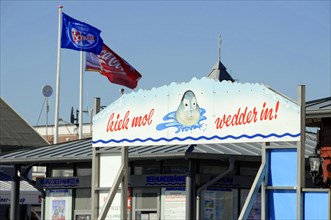 List, Sylt, Schleswig-Holstein, A welcome sign with a seal, surrounded by flag decoration and blue
