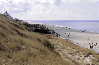 Sylt, Schleswig-Holstein, People enjoying a relaxing day at the beach with dunes in the background,