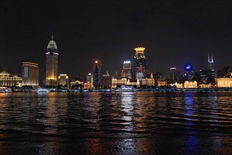 Skyline of Shanghai at night, China, Asia, Luminous skyline of a city reflected in calm water at
