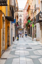 Narrow streets with shops in the city centre of Figueras, Spain, Europe