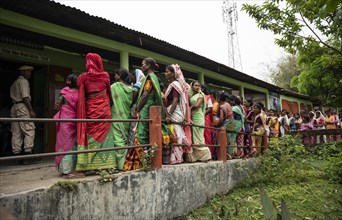 BOKAKHAT, INDIA, APRIL 19: Voters wait in line at a polling station to cast their votes during the