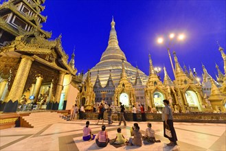 Shwedagon Pagoda, Yangon, Myanmar, Asia, Visitors at the pagoda in the evening light under a deep