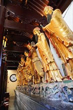 Jade Buddha Temple, Buddha, Puxi, Shanghai, Shanghai Shi, China, row of golden statues inside a