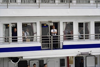 Chongqing, Chongqing Province, China, people looking through ship windows, some socialising, others