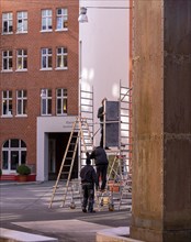 Tradesman with mobile scaffolding, Langer Hof Saarbruecker Strasse, Berlin, Germany, Europe