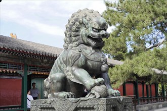 New Summer Palace, Beijing, China, Asia, Statue of a Chinese stone lion in front of traditional