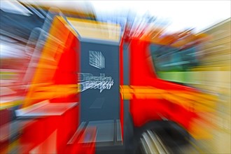 A fire engine at full speed with clear motion blur