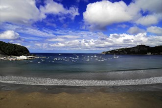 San Juan del Sur, Nicaragua, Panoramic view of a bay with yachts on the water under a wide blue