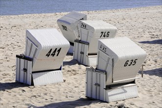 On the beach, Hoernum, Sylt, North Frisian Island, White beach chairs with numbers on a sandy beach