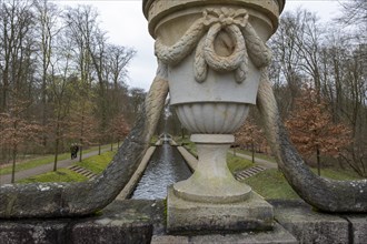 View from a stone bridge with an ornamental vase onto a canal in the castle park, Ludwigslust,