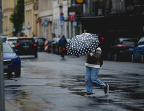 Pedestrians in the rain, taken in Berlin, 19/04/2024