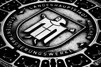 Muenchner Kindl on a manhole cover in the pedestrian zone, Munich, Bavaria, Germany, Europe