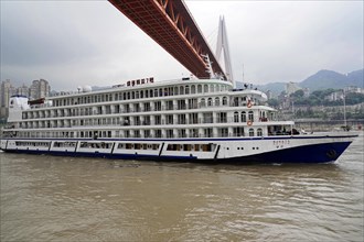 Chongqing, Chongqing Province, China, Side view of a large white cruise ship sailing on a river,