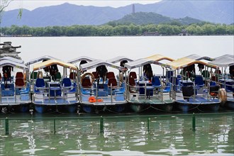 New Summer Palace, Beijing, China, Asia, Several boats on a calm lake in front of a mountain