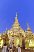 Shwedagon Pagoda, Yangon, Myanmar, Asia, People gather at the Shwedagon Pagoda as dusk colours the