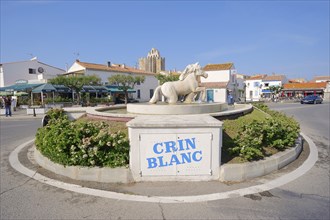 Roundabout with a statue of a Camargue horse in a fountain, Les Saintes-Maries-de-la-Mer, Camargue,