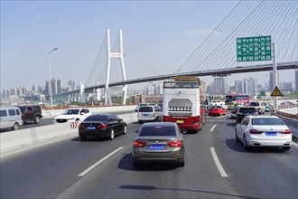 Traffic in Shanghai, Shanghai Shi, Heavy traffic on a motorway with a large bridge in the