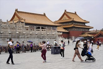 China, Beijing, Forbidden City, UNESCO World Heritage Site, Visitors walk across a wide square in