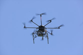 Drone with eight propellers, octocopter, in flight with camera for film and photo shoots, 07.06