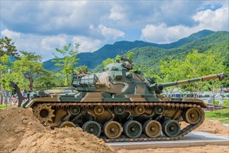 Side view of camouflaged tank used in Korean war on display in public park in Nonsan, South Korea,