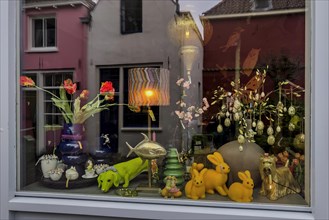 Whimsically decorated shop window with reflection, decoration, idiosyncratic, funny, colourful,