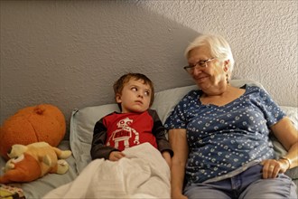 Denver, Colorado, Hendrix Hjermstad, 5, with his grandmother, Susan Newell, 75, at bedtime