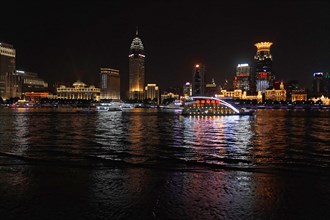 Skyline of Shanghai at night, China, Asia, Colourful city lights reflect in the water during the