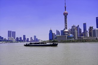 Stroll through Shanghai to the sights, Shanghai, China, Asia, A cargo ship sails on the river in