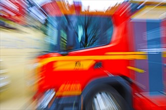 Fire engine in fast motion, which is represented by blurring