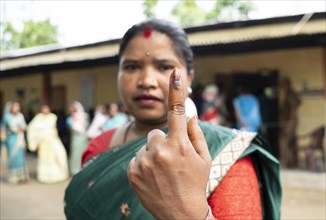 BOKAKHAT, INDIA, APRIL 19: A women show her marked finger after casting vote during the first phase