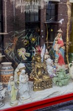 Display window with various religious sculptures, religion, Christianity, Hinduism, Buddha,