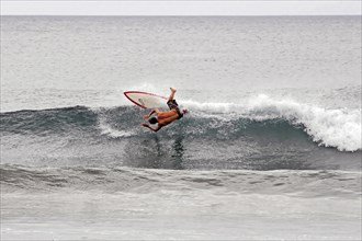 San Juan del Sur, Nicaragua, A surfer performs an acrobatic jump on a wave, Central America,