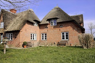 Traditional thatched house with brick walls on a sunny spring day, Sylt, North Frisian Island,
