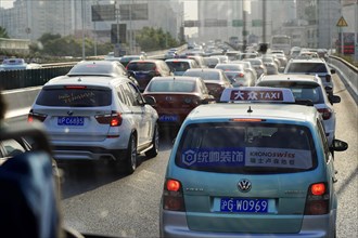 Shanghai, People's Republic of China, Dense traffic with many cars on a city street in sunny