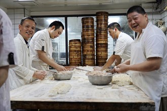 Stroll in Chongqing, Chongqing Province, China, Asia, Kitchen staff prepare dough dishes together