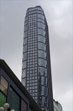 Chongqing, Chongqing Province, China, Asia, A large skyscraper with a glass facade towers into the