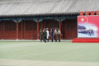 China, Beijing, Forbidden City, UNESCO World Heritage Site, A group in uniforms chatting on the