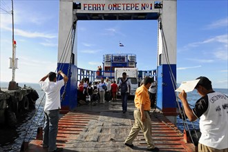 Lake Nicaragua, people boarding a ferry via a jetty, on the shore with clear sky, Nicaragua,