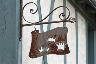 Old nose sign of a former Three Crowns inn, on a half-timbered house, Langeais, France, Europe