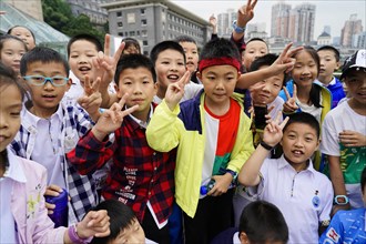 Chongqing, Chongqing Province, China, Asia, Group of students in colourful clothes show joyful